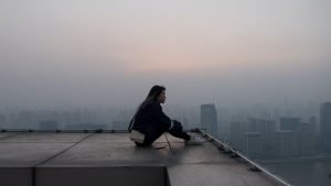 woman on building contemplating and thinking