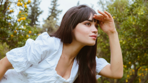 woman looking around in forest
